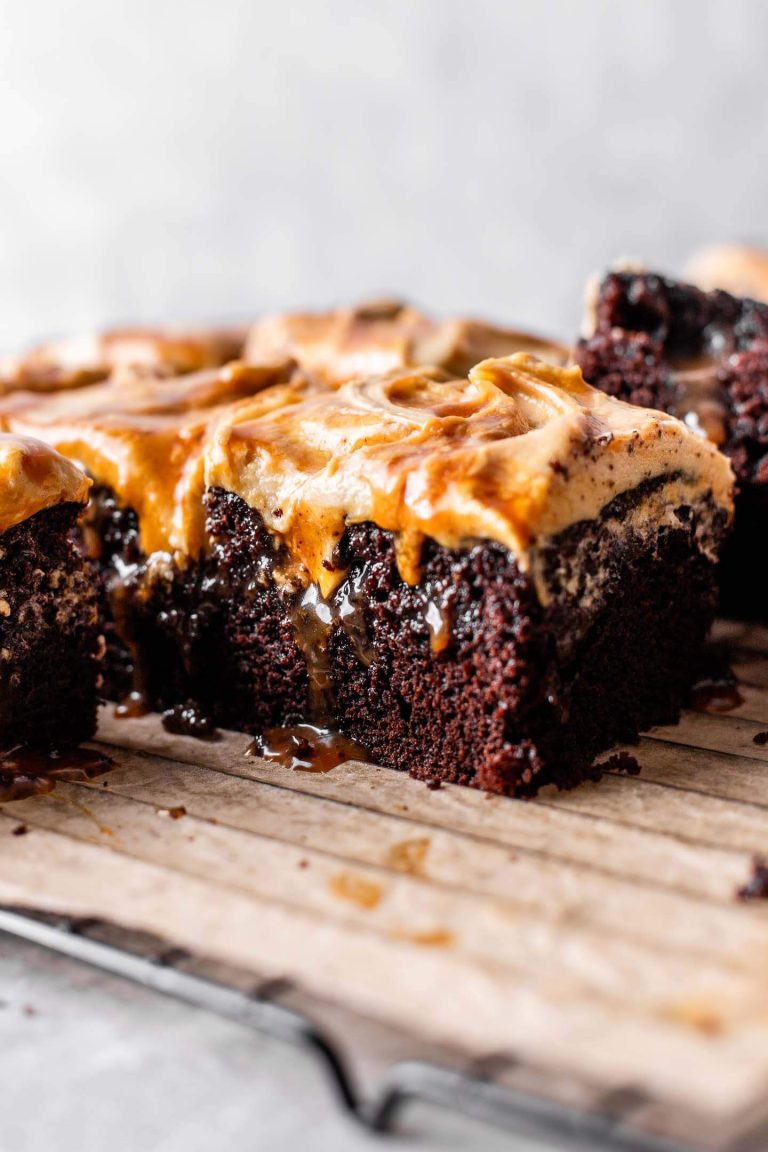 sliced chocolate caramel poke cake on parchment lined wire rack (5)
