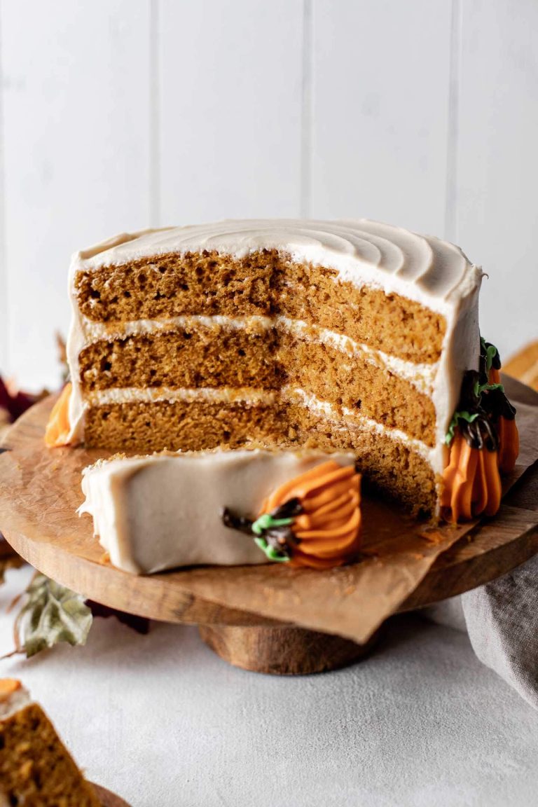decorated pumpkin layer cake on cake stand