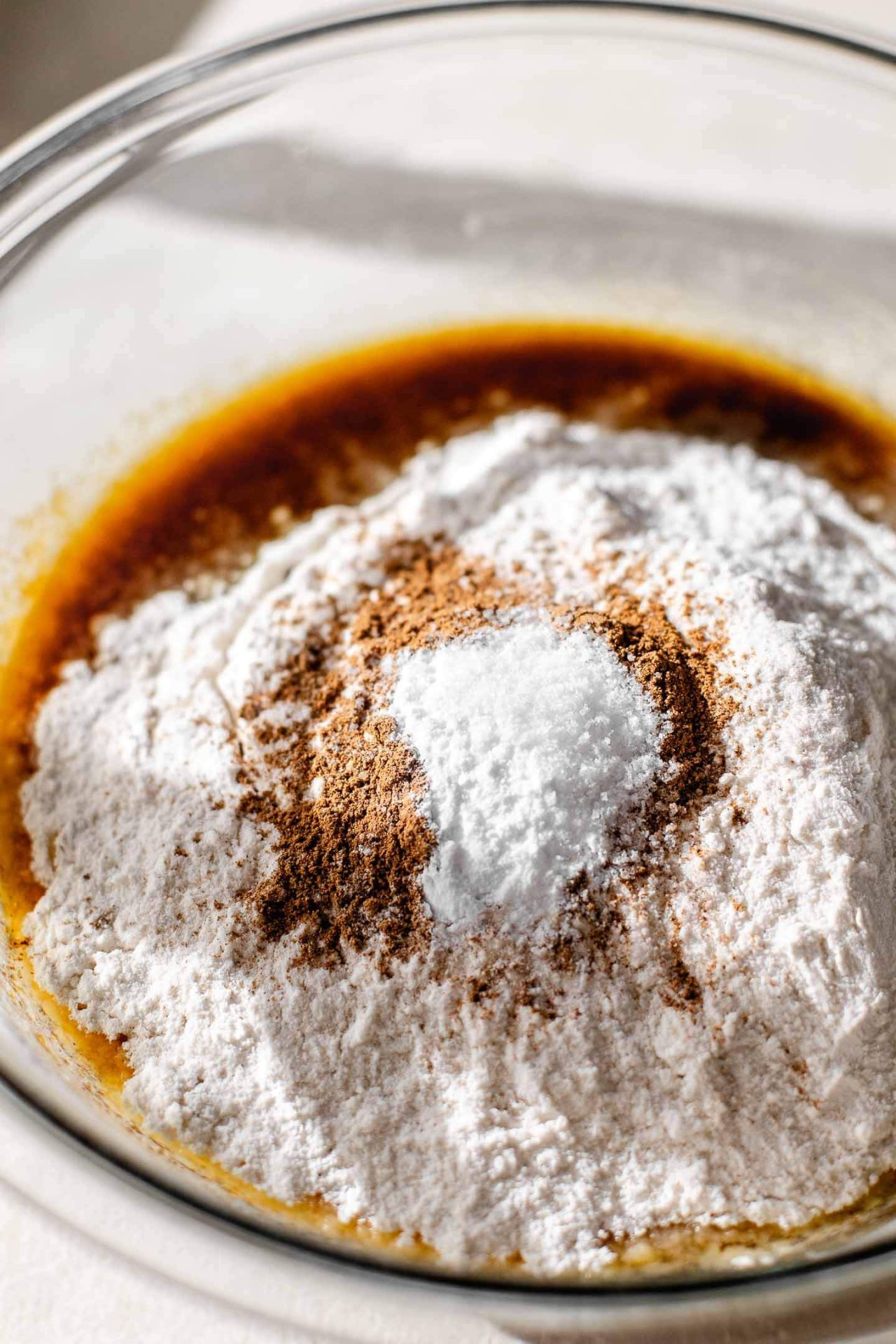 giant pumpkin chocolate chip cookie dry ingredients added to bowl with wet ingredients