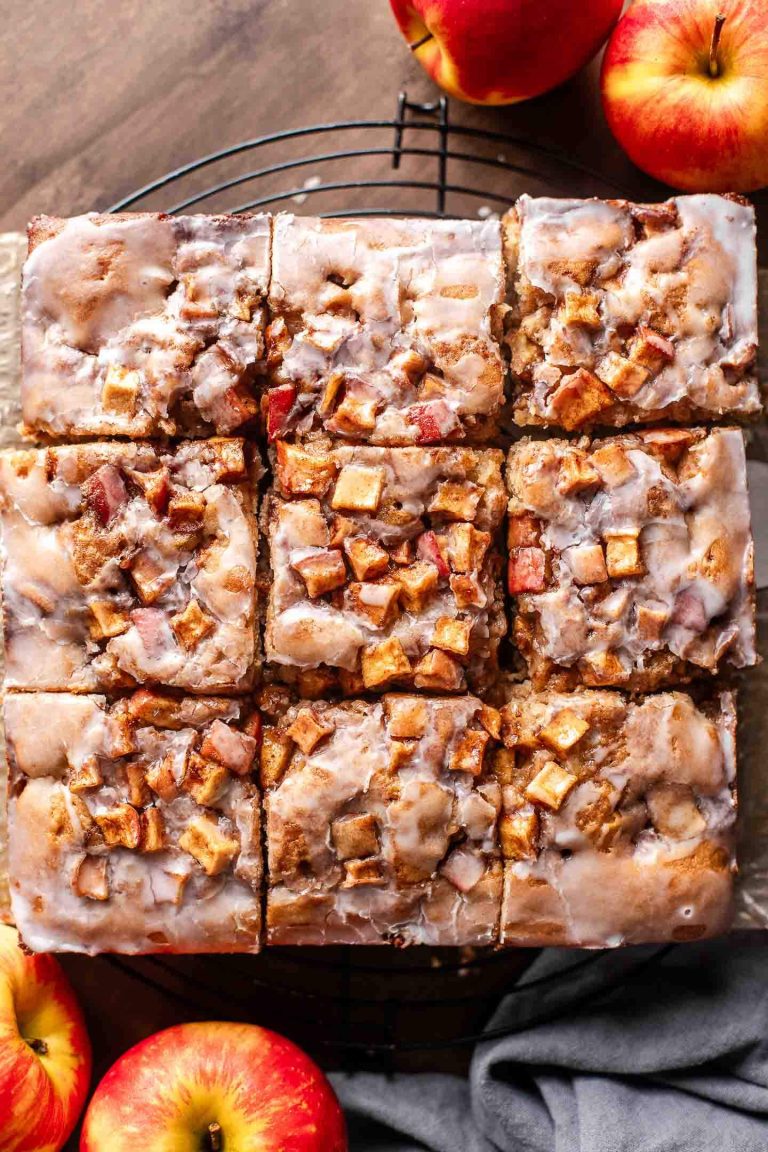 sliced apple fritter cake on parchment lined wire rack