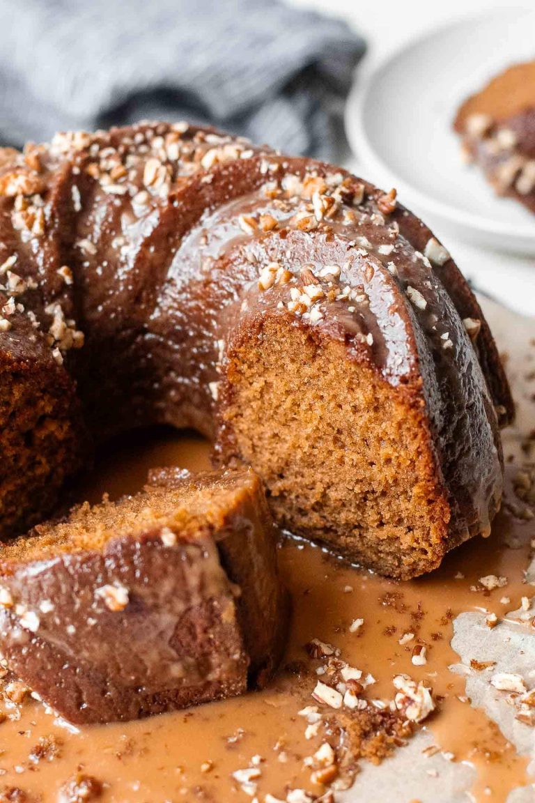 iced and sliced date syrup cake on parchment lined wire rack
