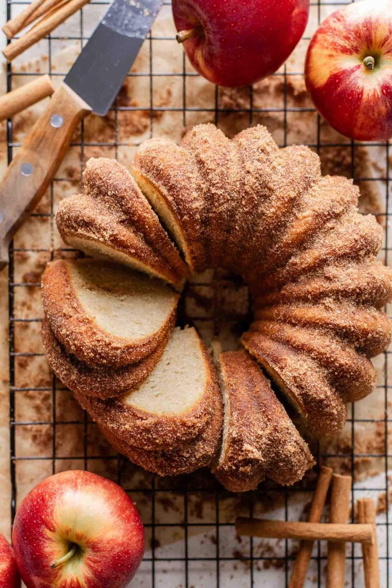 sliced apple cider donut cake on wire rack