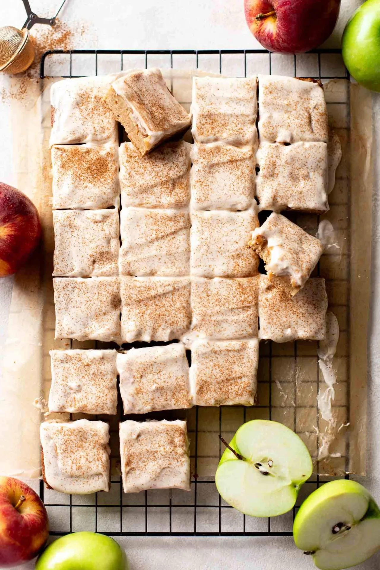 iced brown butter apple blondies on parchment lined wire rack