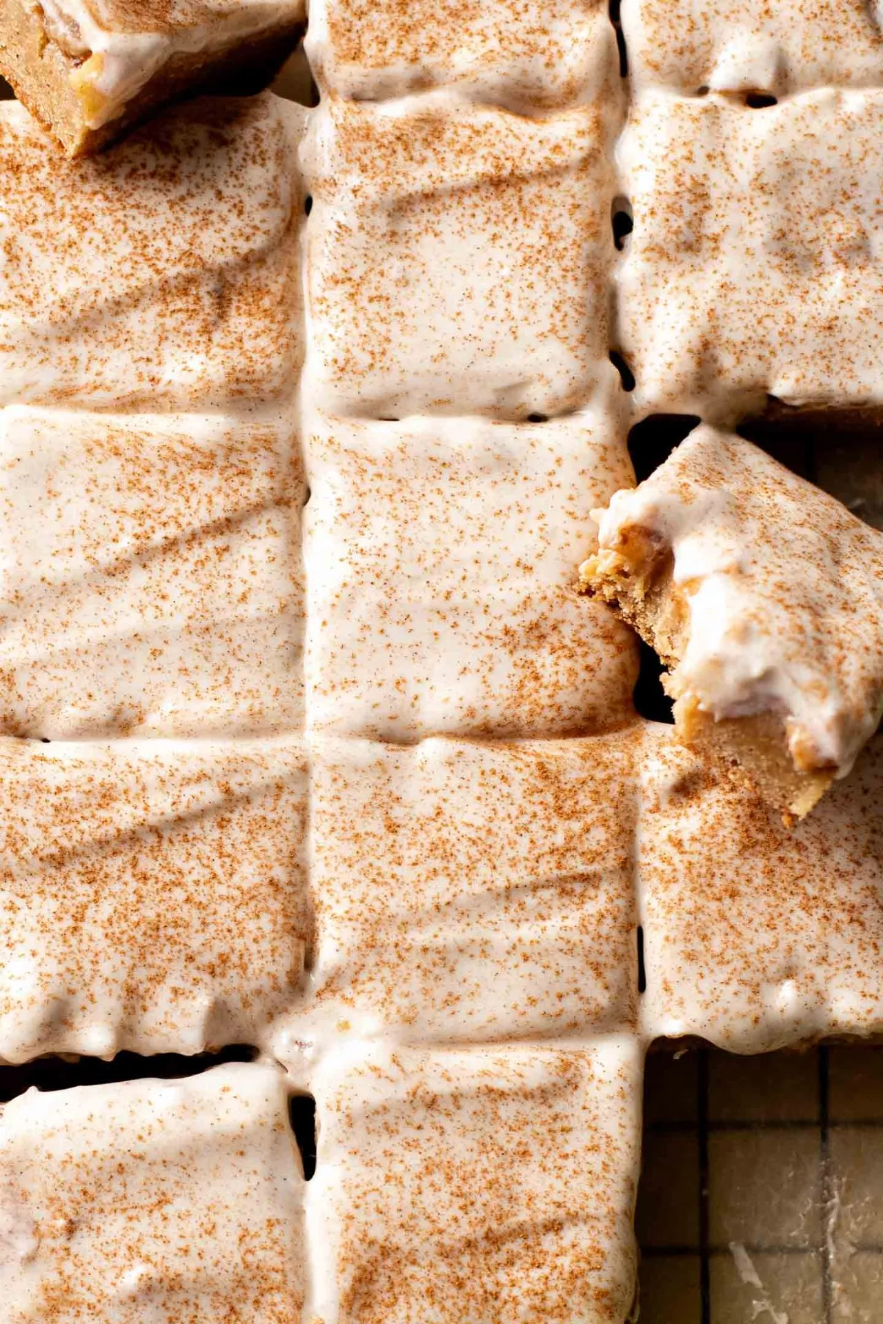 iced brown butter apple blondies on parchment lined wire rack