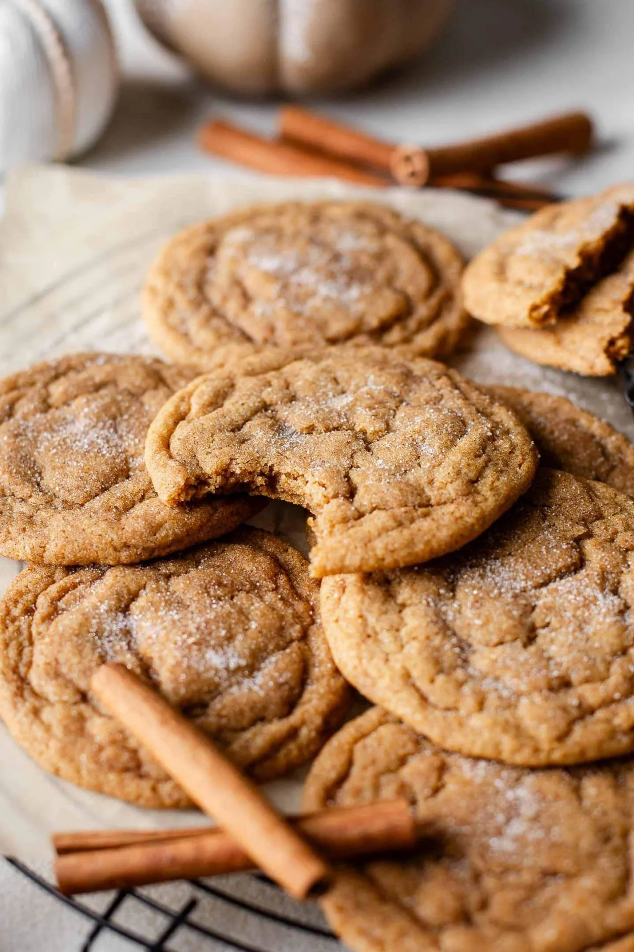 chewy pumpkin cookies on wire rack with bite missing from one