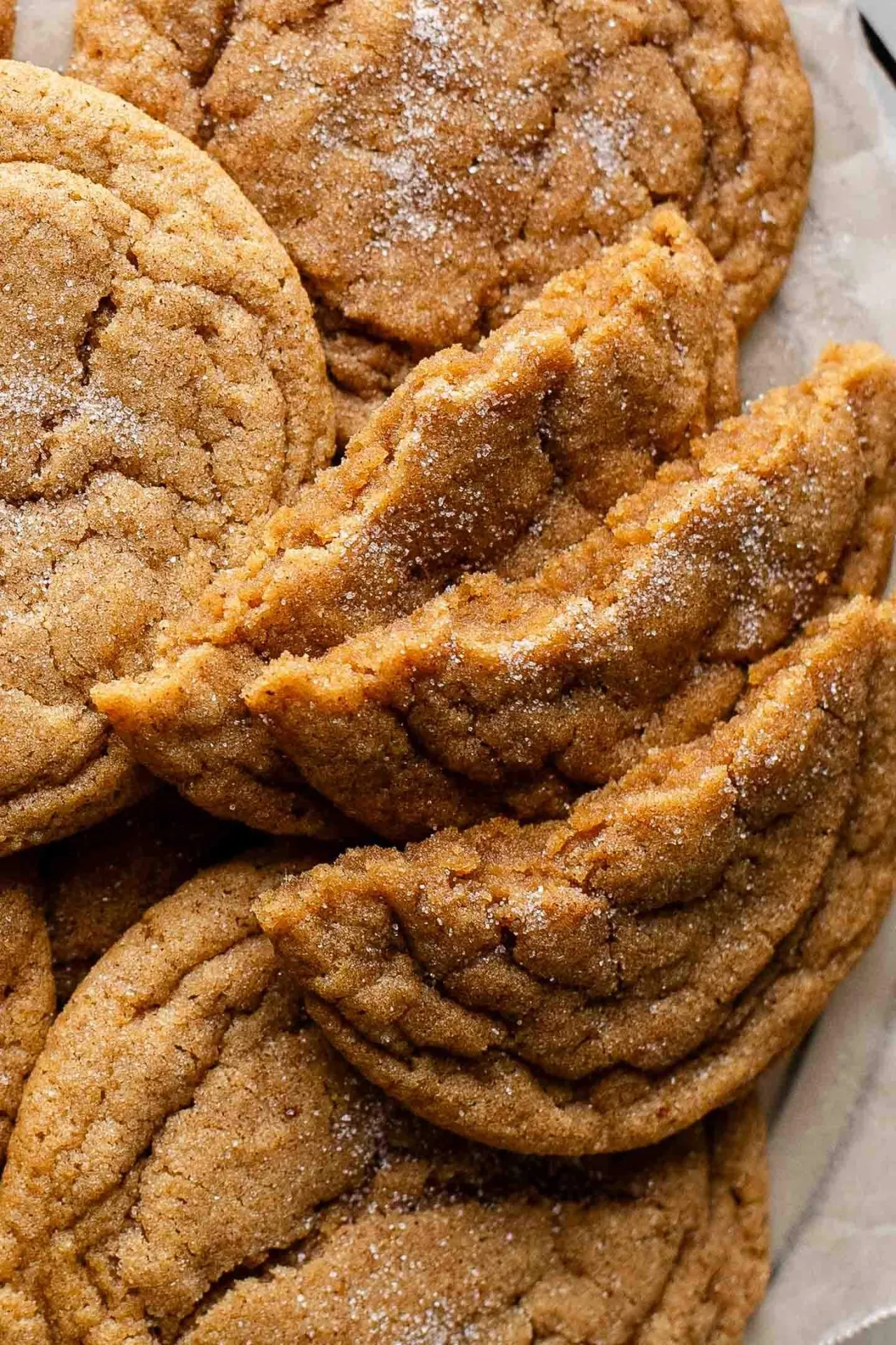 chewy pumpkin cookies on wire rack with 3 half cookies fanned out