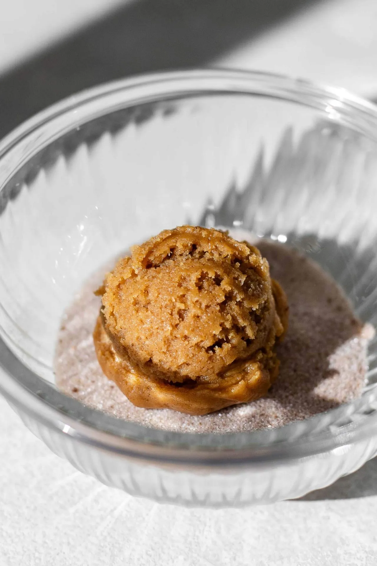 chewy pumpkin cookie scoop of dough in bowl of spice sugar