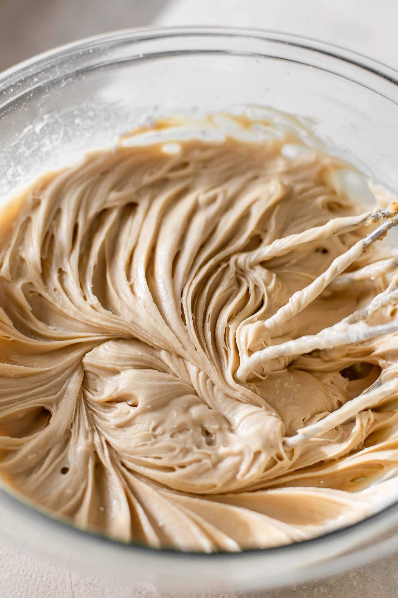 cinnamon roll ooey gooey butter cake cream cheese and brown sugar combined in bowl