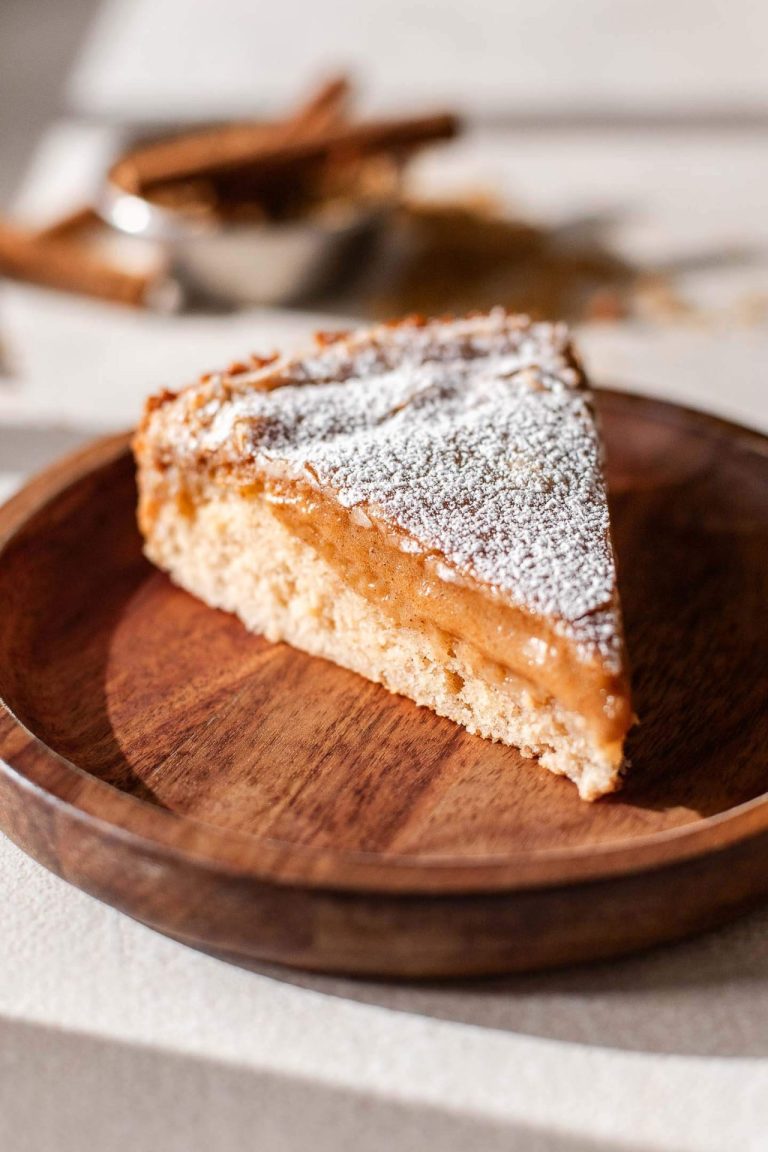 slice of cinnamon roll ooey gooey butter cake in plate