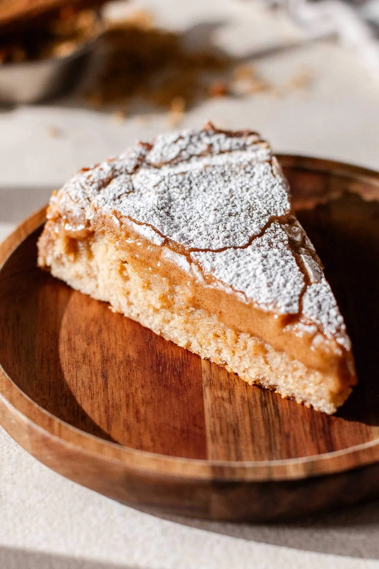 slice of cinnamon roll ooey gooey butter cake in plate