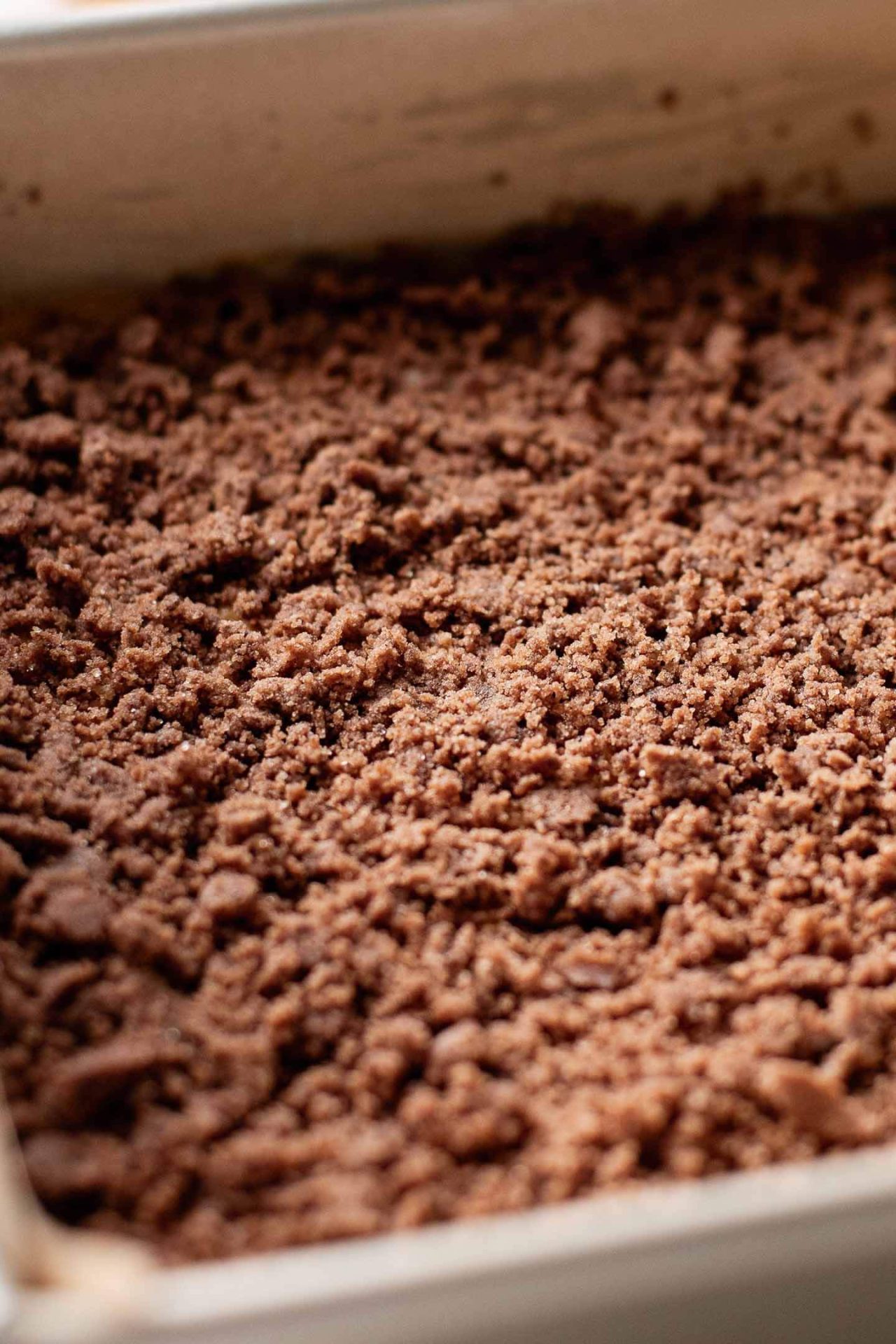 pumpkin coffee cake cinnamon swirl mixture sprinkled over first layer of cake batter in pan